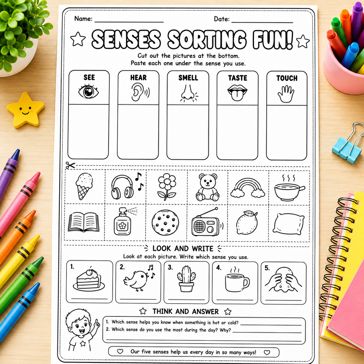 A children's sensory sorting worksheet titled 'SENSES SORTING FUN!' laid flat on a light wood surface. The page contains black-and-white line drawings of senses (eye, ear, nose, tongue, hand) and various objects such as an ice cream cone, headphones, flower, bear, rainbow, steam, book, bottle, cookie, radio, and pillow.